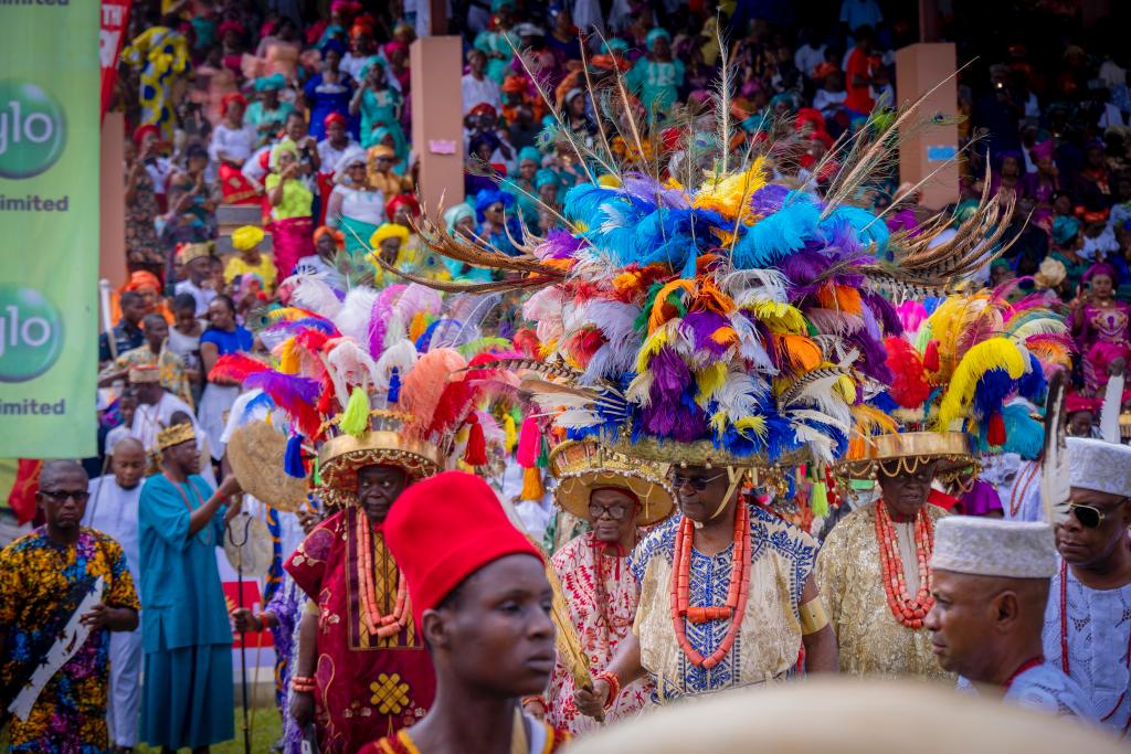 Vibrant scene from the Onitsha Ofala Festival 2024 showcasing colourful Igbo fashion and cultural performances, highlighting themes of courage and self-reliance.