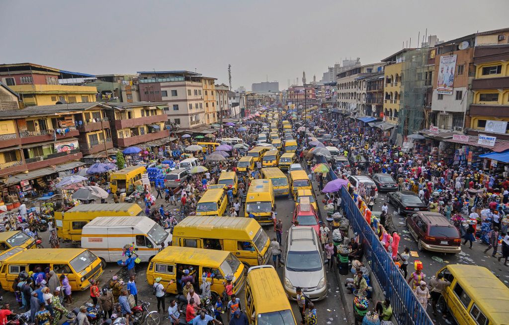 This picture depicts cars and a crowd stuck in traffic, which is one of the small culture shocks that visitors experience in Nigeria.